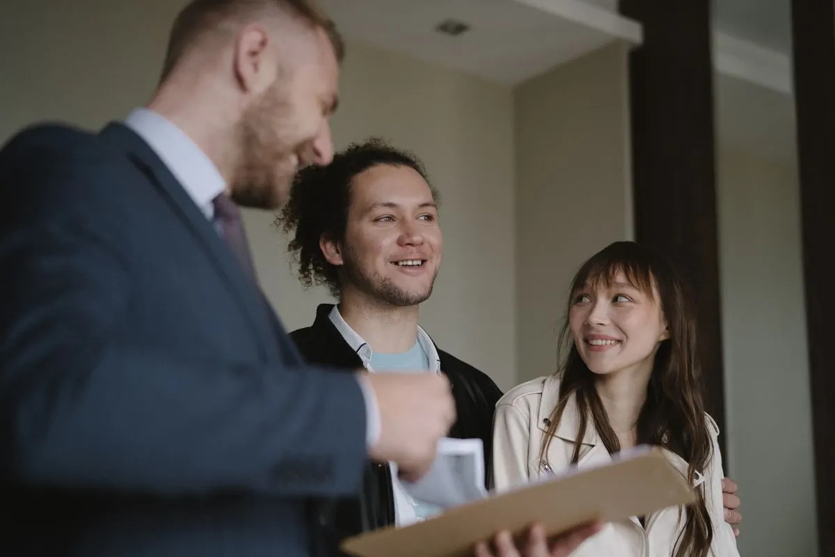Home buyers talking with their real estate agent
