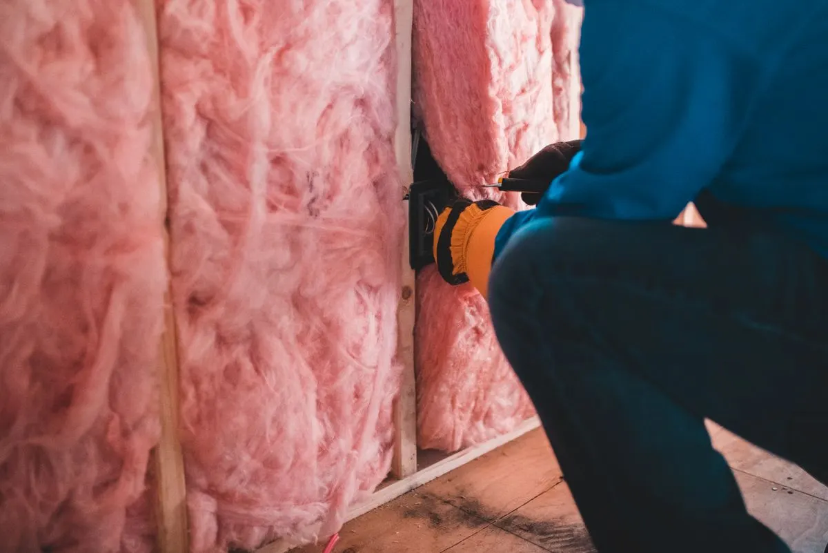 Loose insulation between attic joists in an older house